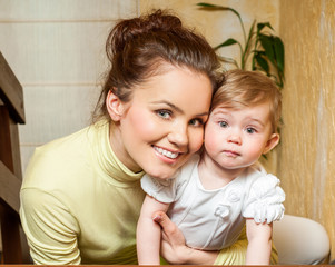 Mother and baby playing and smiling. Happy family.Home interior.