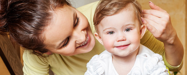 Mother and baby playing and smiling. Happy family.Home interior.