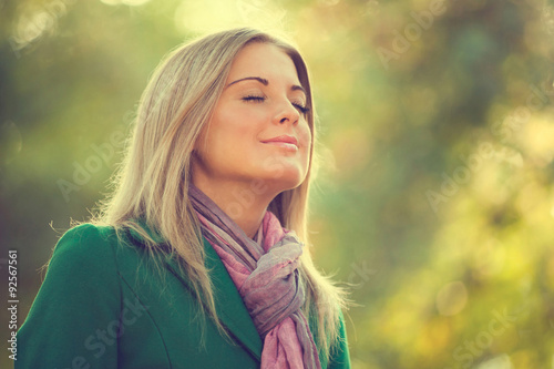 Fotomural Young woman enjoying fresh air in autumn, intentionally toned.