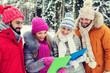 © Syda Productions - smiling friends with tablet pc in winter forest