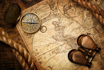 Fototapete - old compass, binoculars and rope on vintage map