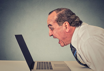 furious business man working on computer, screaming