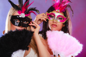 Two women with carnival venetian masks