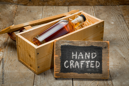 Fotografie, Obraz Hand crafted whisky bourbon rum spirit bottle in wooden gift package box