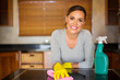 © michaeljung - young woman cleaning in the kitchen