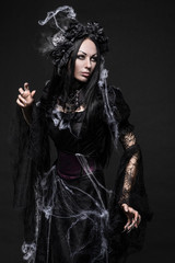 Portrait of beautiful Gothic woman in dark dress in studio