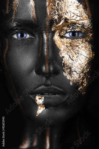 Naklejka dekoracyjna fashion portrait of a dark-skinned girl with gold make-up. Beauty face.