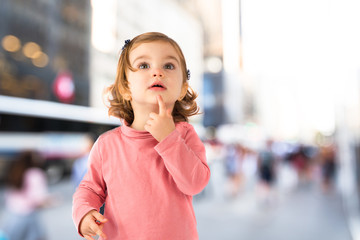 Little girl thinking over white background