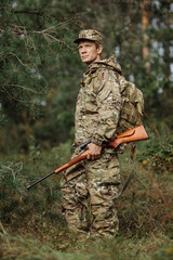 Wall Mural - hunter in camouflage clothes ready to hunt with hunting rifle