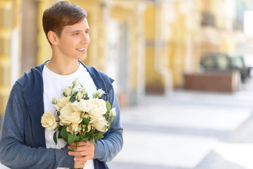 Handsome guy holding flowers 