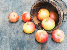 Red Apples Drop Out From Wooden Bucket