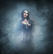 © Acronym - Halloween concept: young and sexy witch makes the witchcraft in