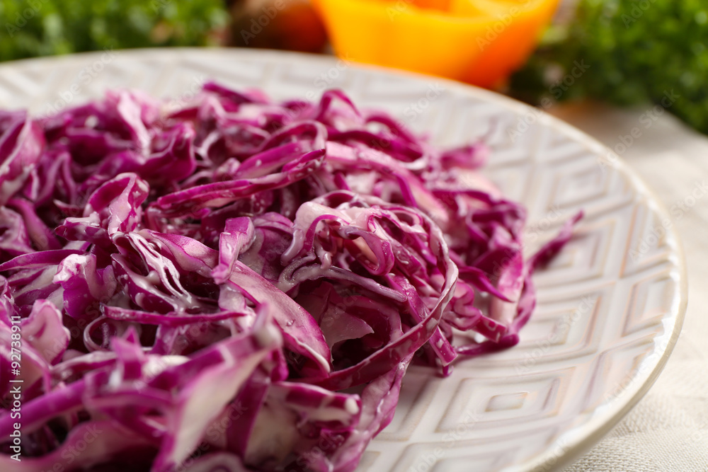 Red cabbage salad served on plate closeup