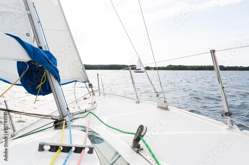 Front part of yacht swimming on lake.