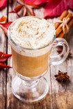 Fototapeta Kwiaty - pumpkin latte with whipped cream in a glass jar