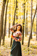 © satura_ - Young woman with autumn leaves in hand