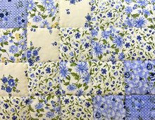 Close Up Of An Old-fashioned Blue Floral Patchwork Quilt 