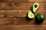 Fototapeta  - Background fresh avocado on the dark wooden table