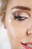 Fototapeta Panele - Close-up face of a girl with a festive make-up. Focus on star