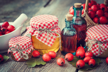 Wall Mural - jars of honey, tincture bottles and mortar of hawthorn berries o