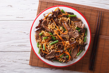 Wall Mural - Chinese noodles with beef, muer and vegetables. Horizontal top view
