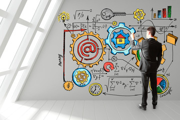 Canvas Print - Businessman draws a startup plan on the wall