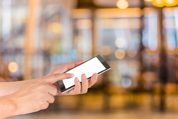 Wall Mural - male hand is holding a modern touch screen phone and Coffee shop