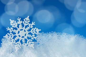 Wall Mural - christmas background with a decorative snowflake on an ice edge