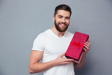 Smiling Casual Man Holding Gift Box
