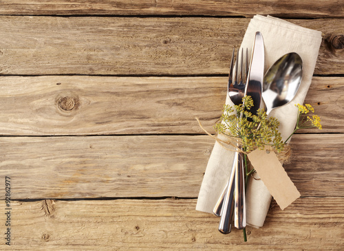 Fotografie, Obraz Cutlery Tied on Napkin with Small Leaves and Tag