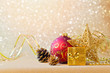 © maglara - Christmas decorations in red and gold over glitter sparkle background