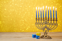 Jewish Holiday Hanukkah Background With Vintage Menorah And Spining Top Dreidel Over Lights Bokeh