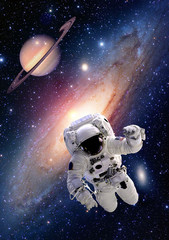 Wall Mural - astronaut spaceman suit outer space saturn planet milky way universe. elements of this image furnish
