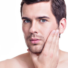 Wall Mural - Young man with hand near the face.