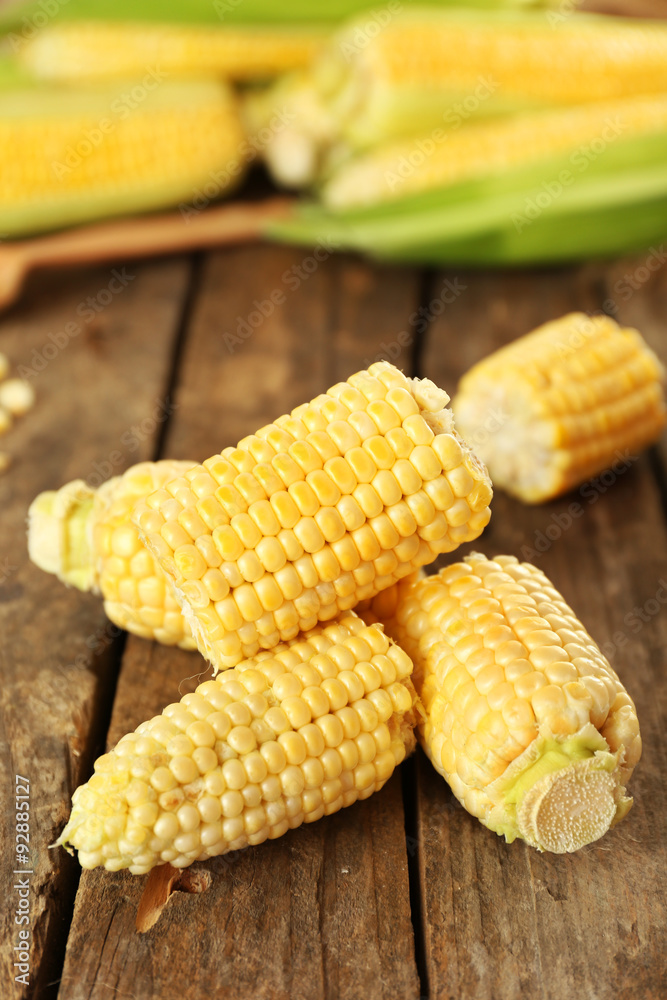 Fresh corn on cobs on rustic wooden table, closeup
