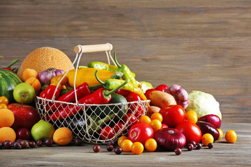 Heap of fresh fruits and vegetables on wooden background