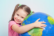 © Myst - cute little girl hugging globe. save the earth concept.