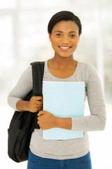Wall Mural - female afro american student holding a book