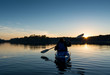 Woman Kayaking at Sunset