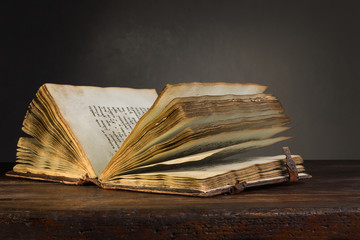 Old open book on a table.