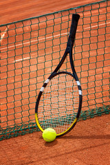 Tennis racket and ball on the court.