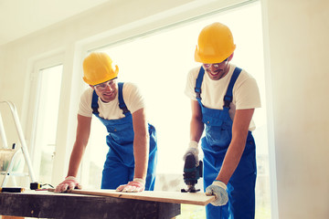 Canvas Print - group of builders with tools indoors