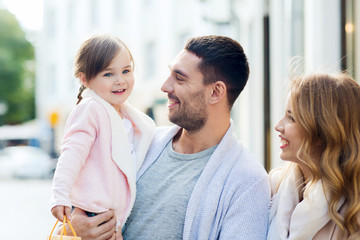 Canvas Print - happy family with child and shopping bags in city