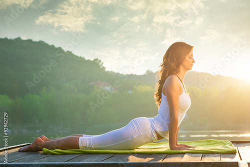 Stampa su Tela Woman doing yoga on the lake - relaxing in nature