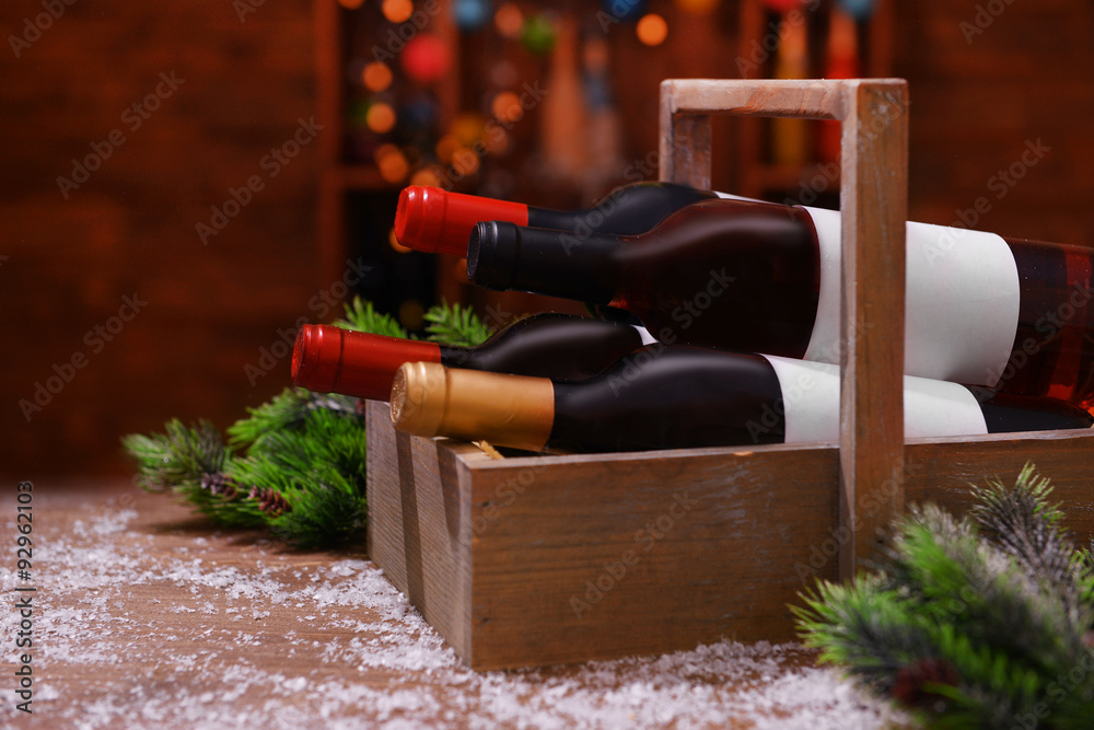 Beautifully decorated box with bottles of wine on unfocused background