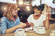 © Flamingo Images - Two pretty young woman enjoying coffee