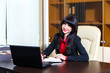© angor75 - Beautiful smiling woman working with laptop in the office