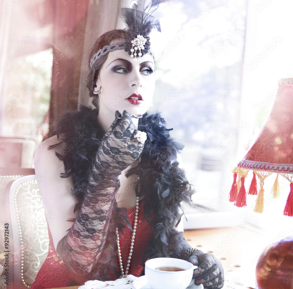 Retro Charleston Woman Fashion of1920 - 1930 Sitting with in a Restaurant  or Cafe Holding a Cup of Tea in Black Lace and Accessories in Style 1920s -  1930s Stock Photo | Adobe Stock