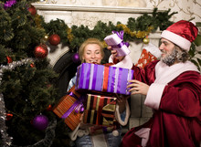 Portrait Of Funny Santa Claus At Home With Christmass Tree, Real