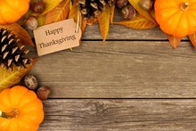 Happy Thanksgiving Gift Tag With Corner Border Of Colorful Leaves And Pumpkins Over A Rustic Wood Background